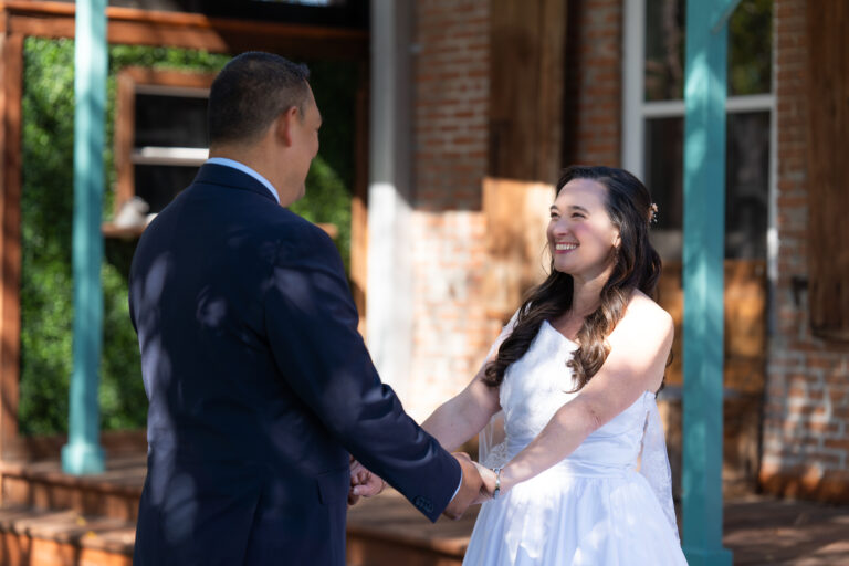couple in garden wedding area under trees white chairs all around